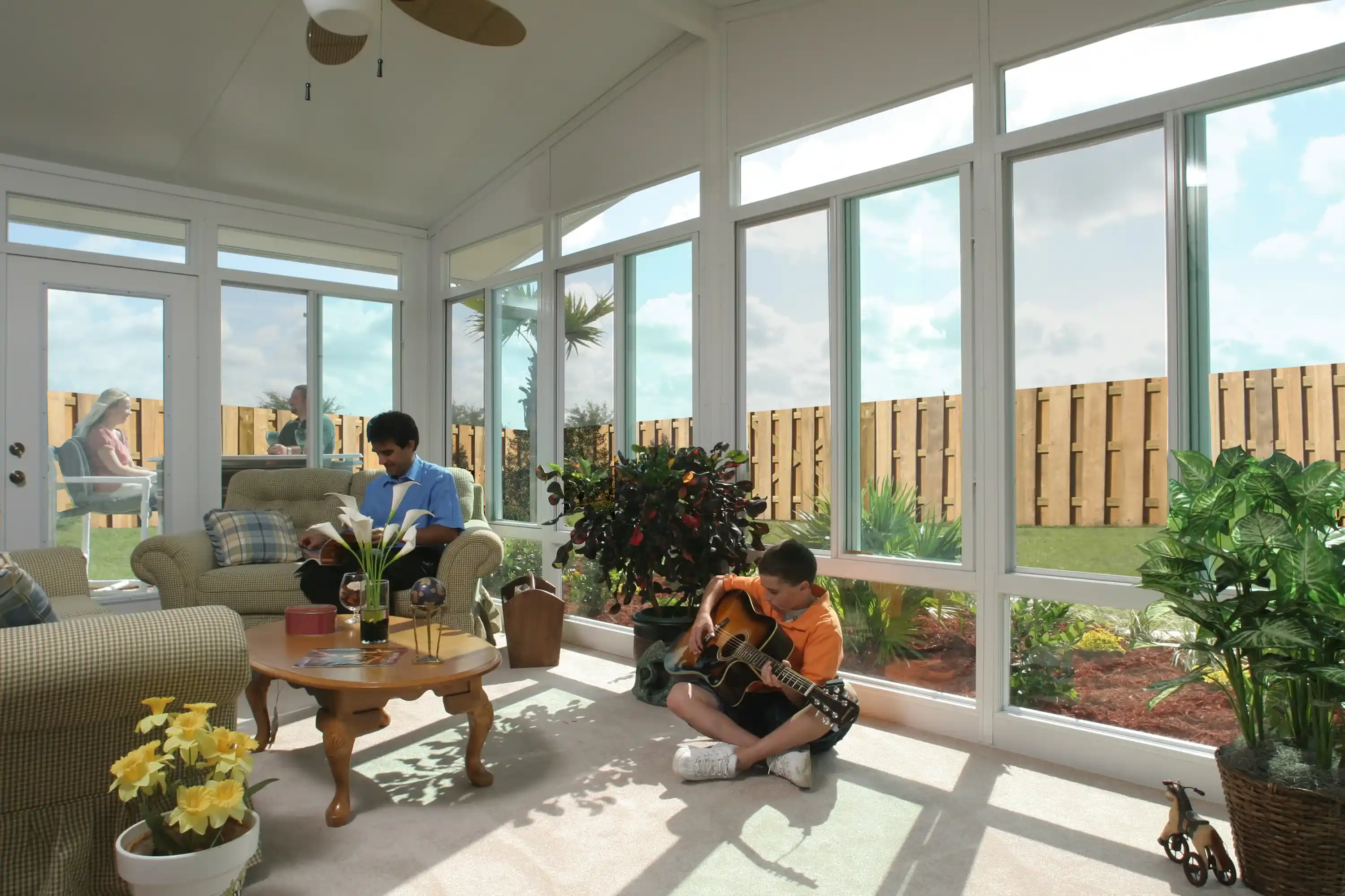 Family relaxing in a bright sunroom