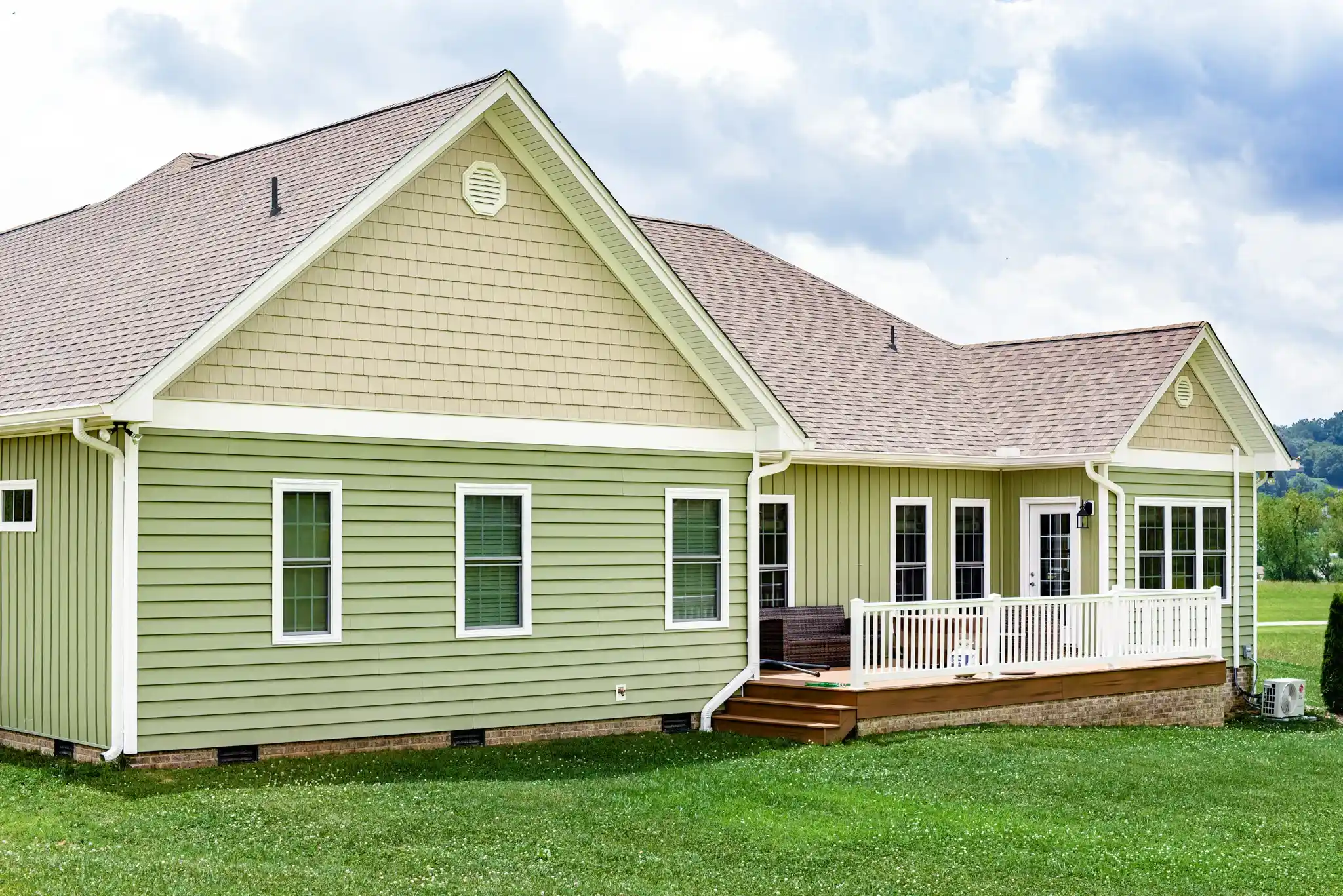 Green lap siding with white trim on a North Texas home exterior