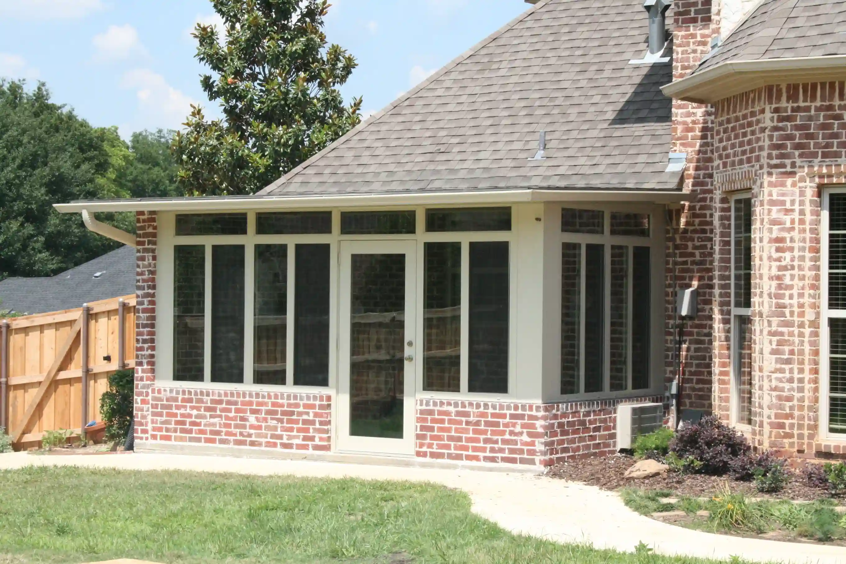 Screened patio on a brick facade