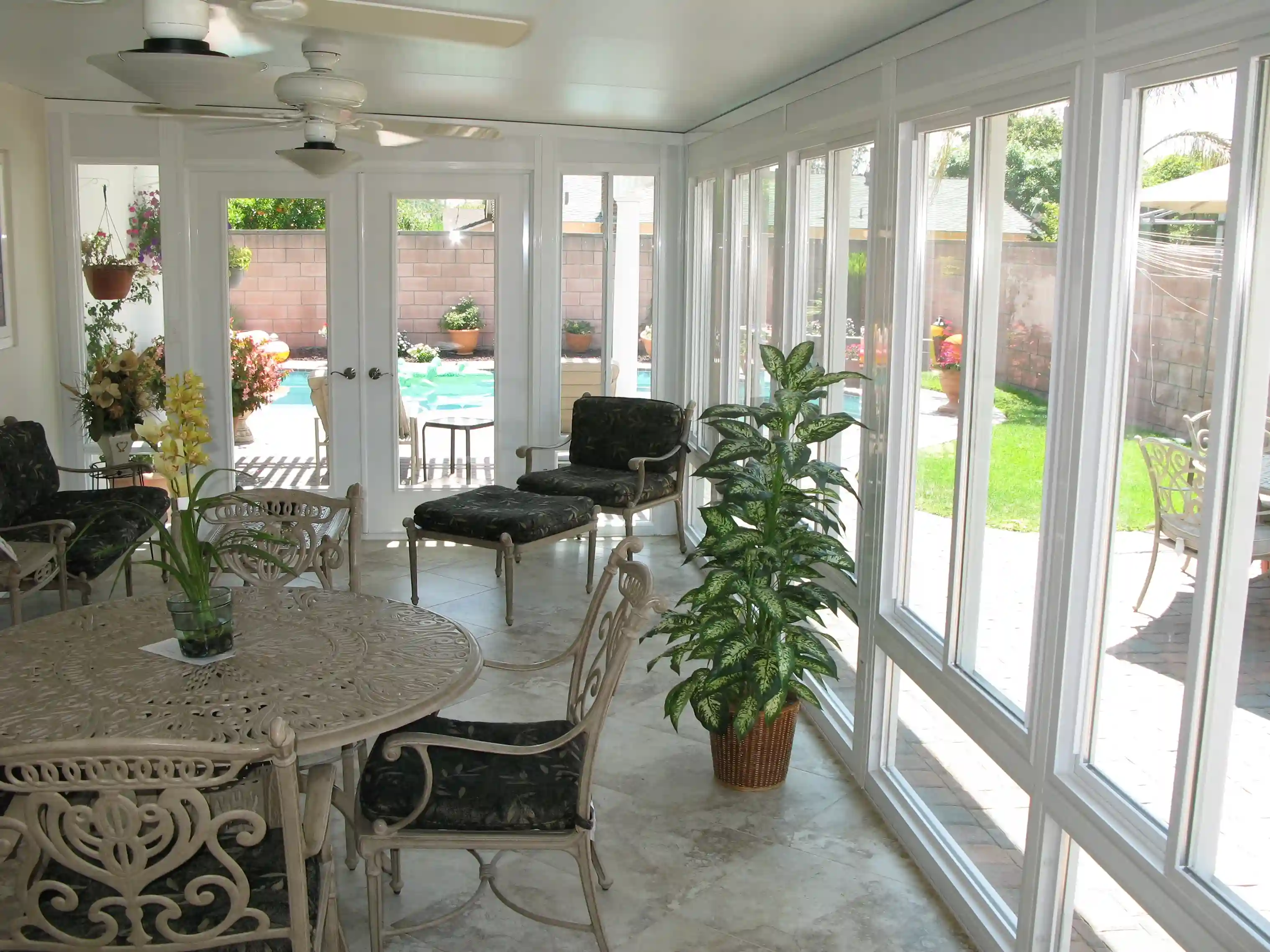 Sunroom dining space beside a pool