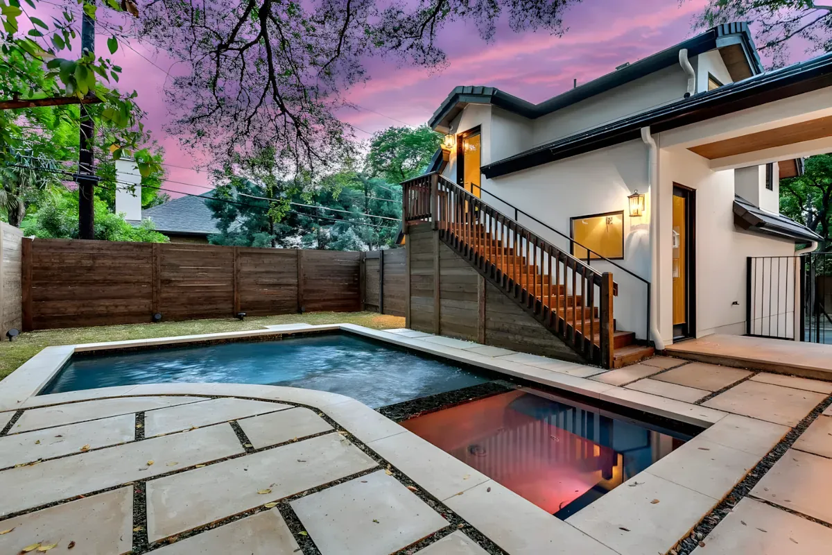 Pool and spa at dusk under a pink Texas sky