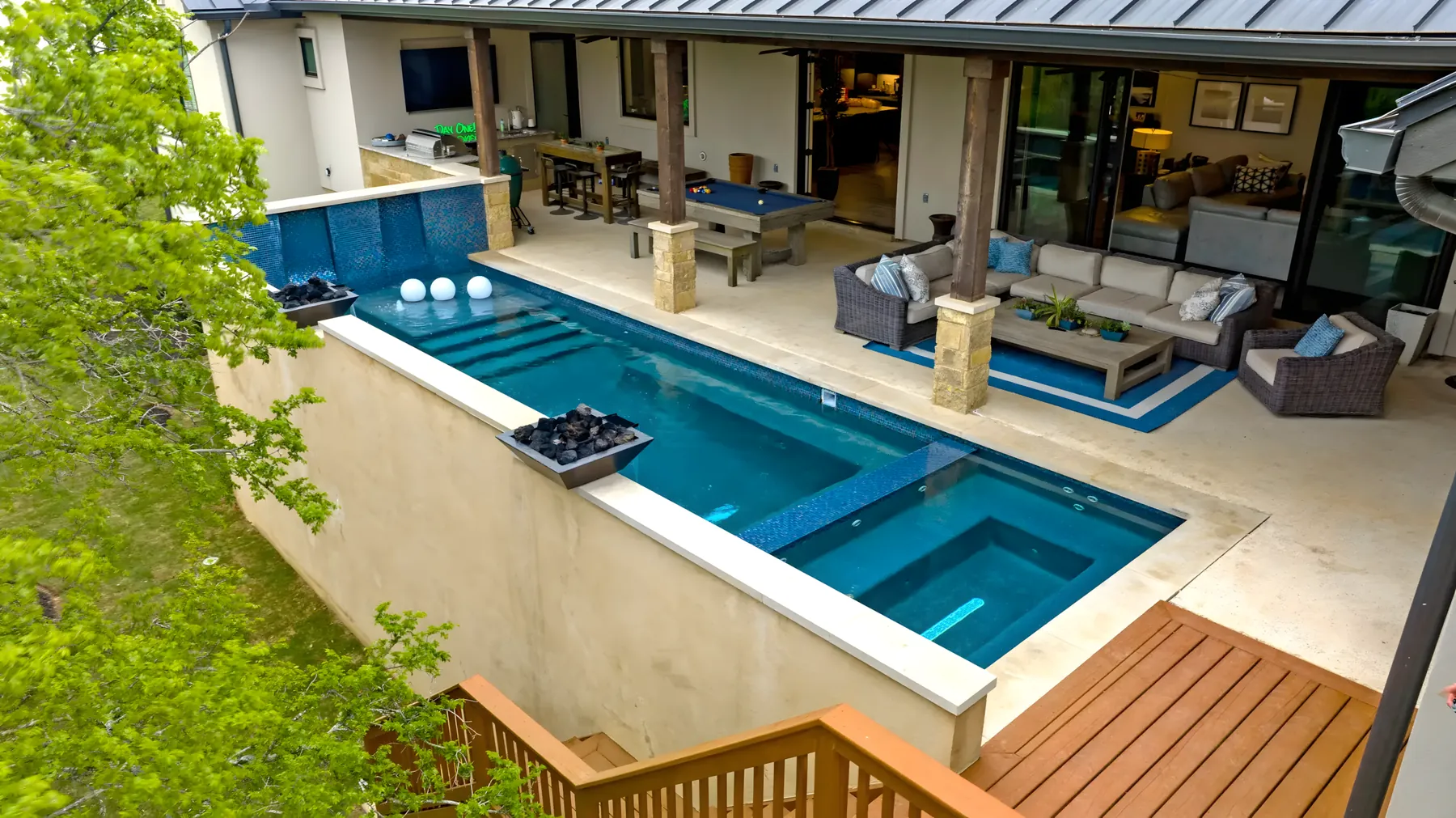 Aerial view of a pool, covered lounge and dining terrace