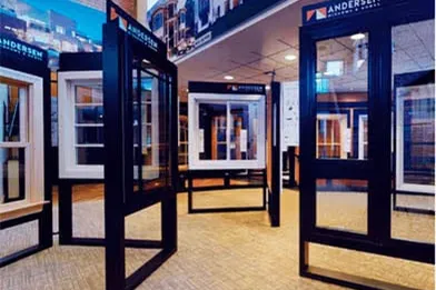 Showroom displaying black and white framed window samples in various styles and glass pane designs