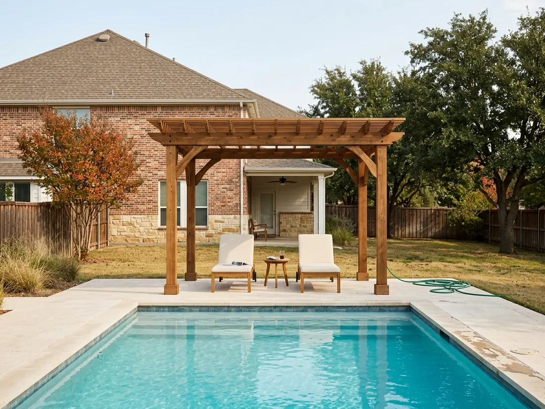 Cedar pergola shading lounge chairs at the short end of a sunlit backyard pool