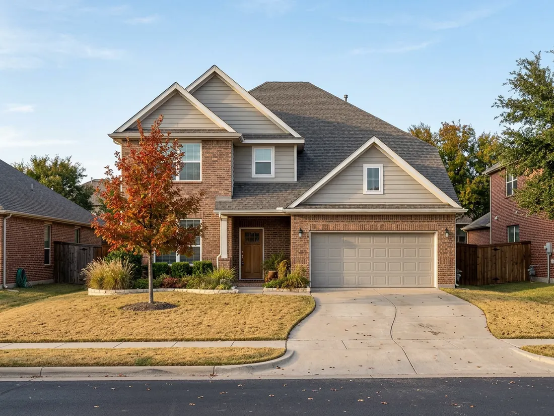 Brick home with greige fiber cement siding on gables and dormers in a North Texas fall afternoon