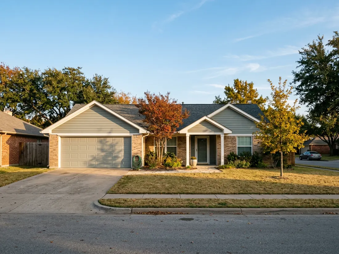 Brick ranch home in North Texas with sage insulated vinyl siding on a bright fall afternoon