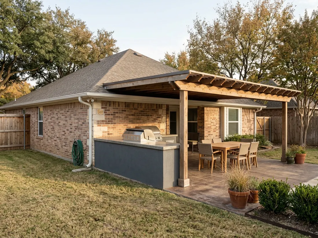 Outdoor kitchen island beside a pergola with a solid roof section over the grill on a DFW patio