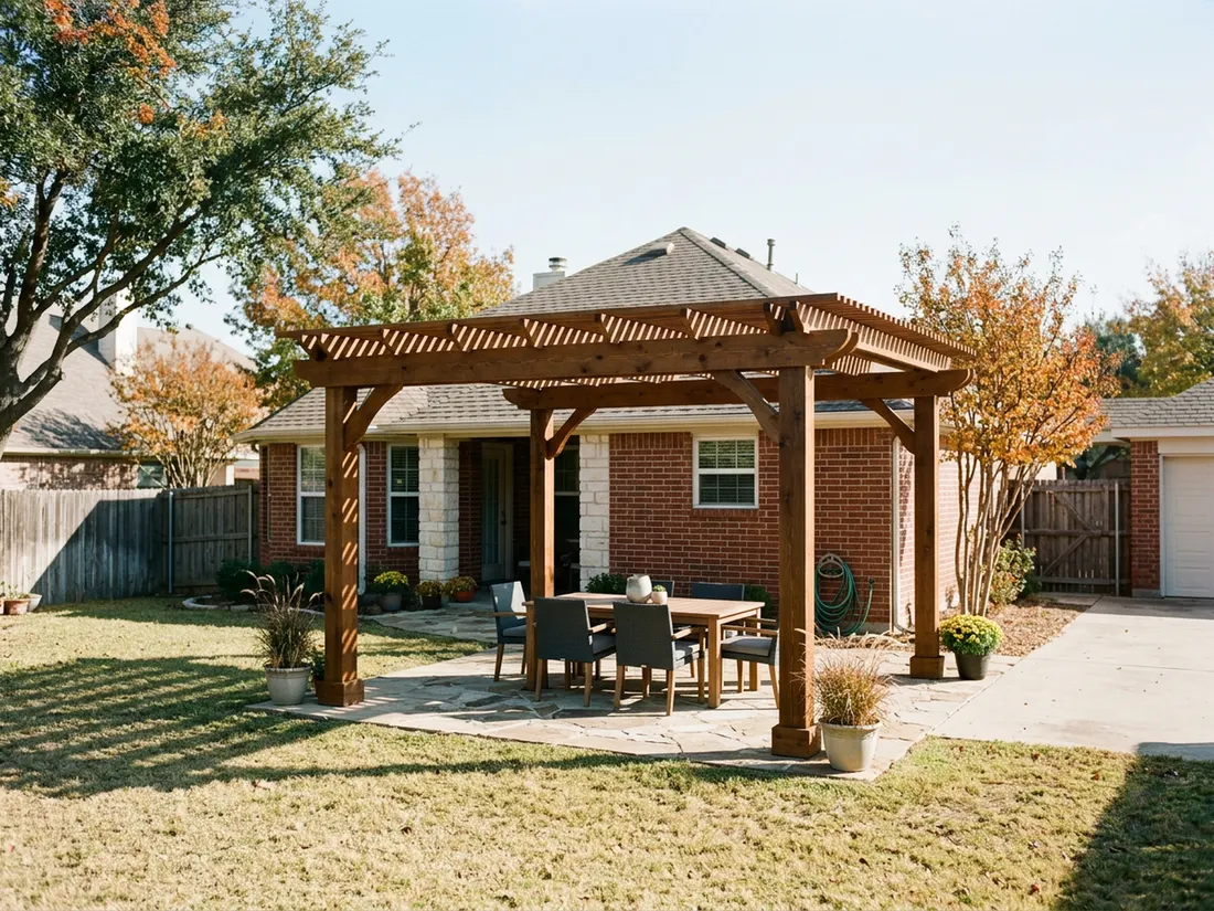 Cedar pergola over a flagstone patio behind a brick Dallas house in autumn afternoon light