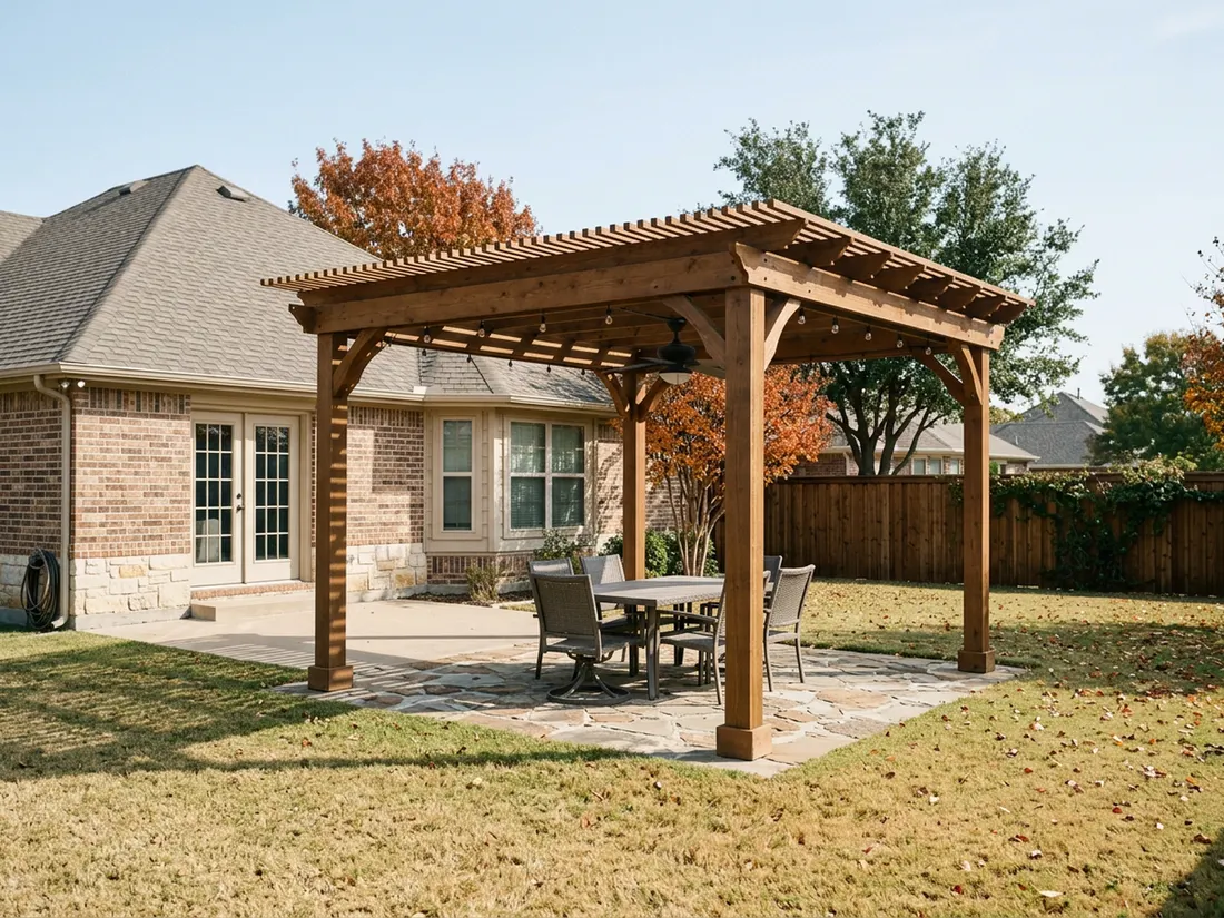 Cedar pergola with ceiling fan and string lights over a flagstone patio behind a Texas brick home