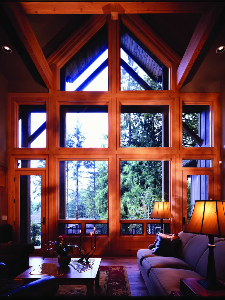Living room featuring a tall wall of wood-framed windows beneath high vaulted timber ceilings