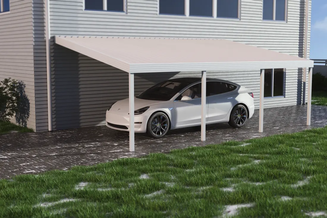 White metal attached carport sheltering a white car on a paved driveway beside a house