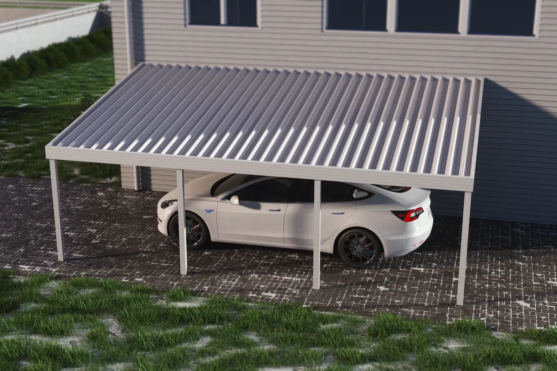 White metal attached carport with corrugated roof sheltering a car on a paved driveway