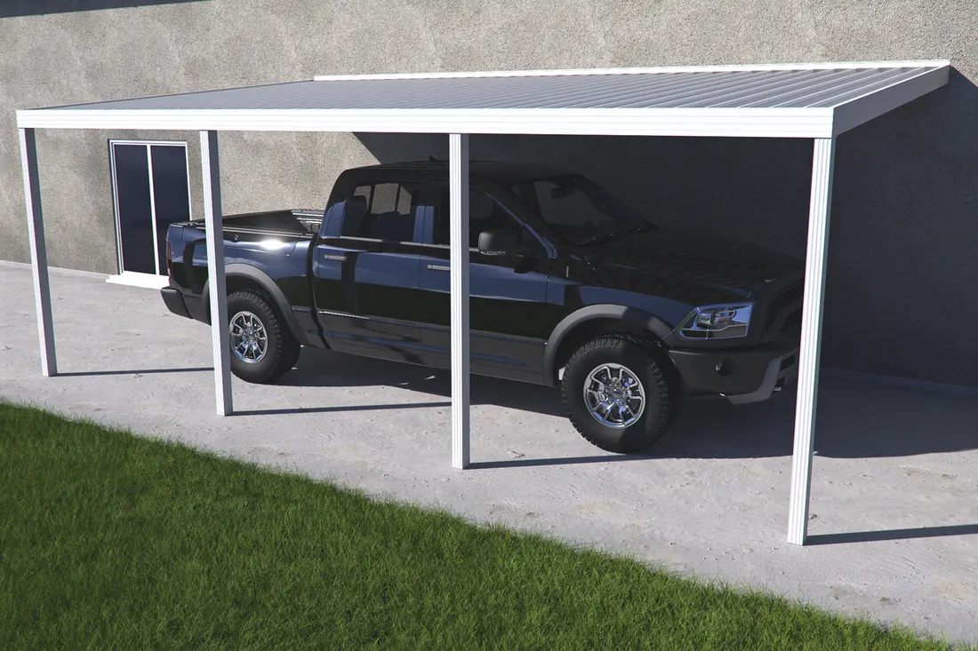 White metal carport sheltering a dark pickup truck beside a gray building and green lawn
