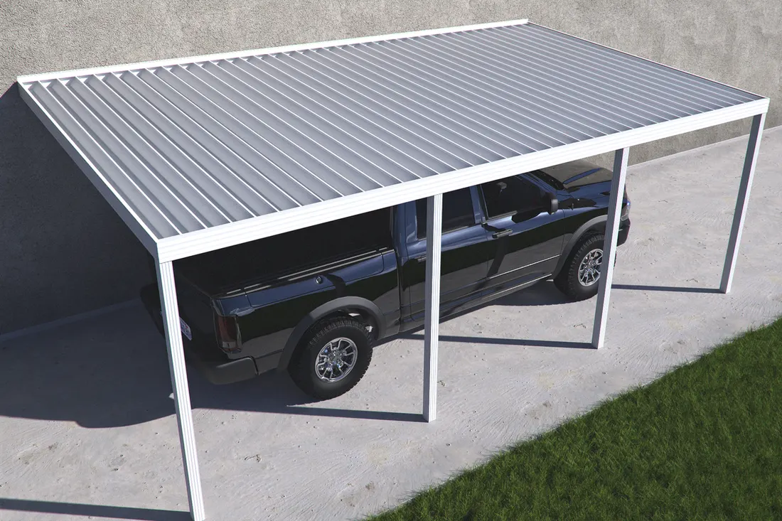 Attached white metal carport with corrugated roof covering a black pickup truck on concrete