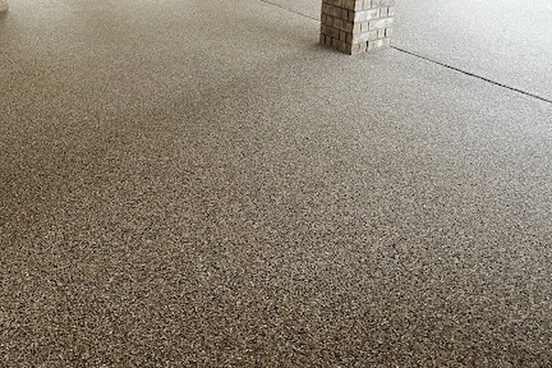 Speckled gray patio floor coating surrounding a brick column and expansion joint