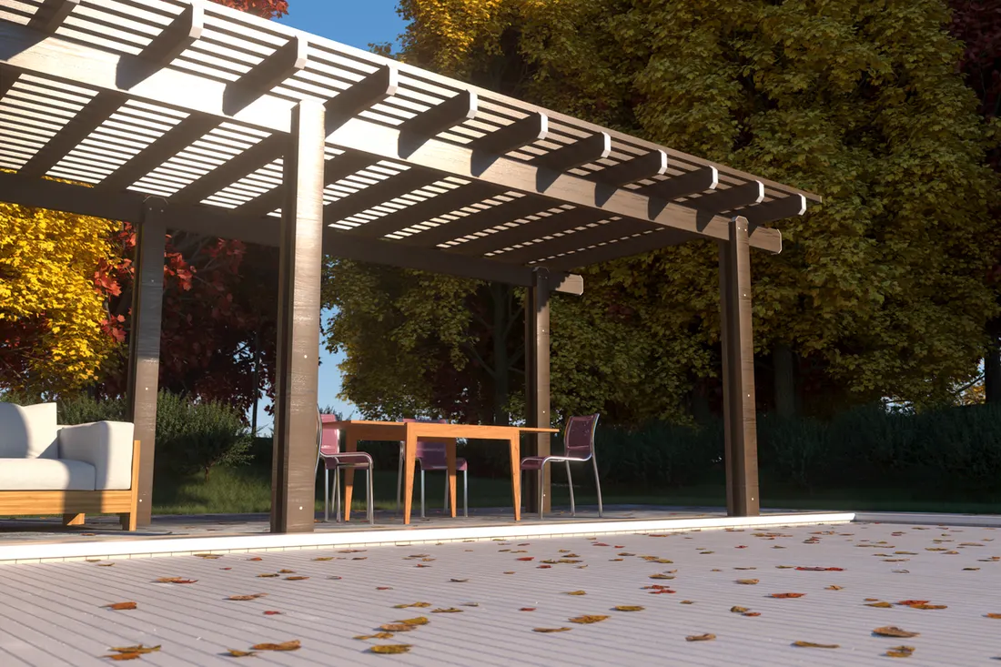 Gray-stained wooden pergola with slatted roof over patio seating and dining area, surrounded by trees