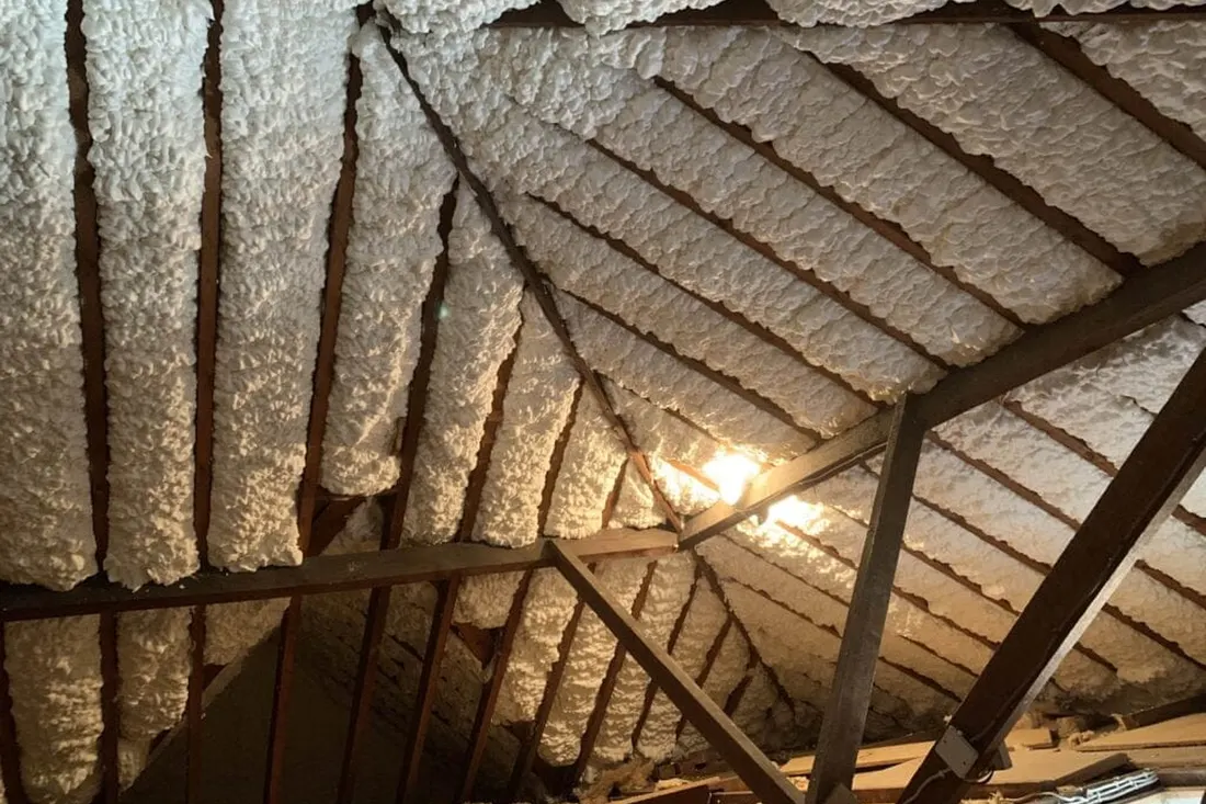 Sprayed foam insulation covering attic rafters and roof decking