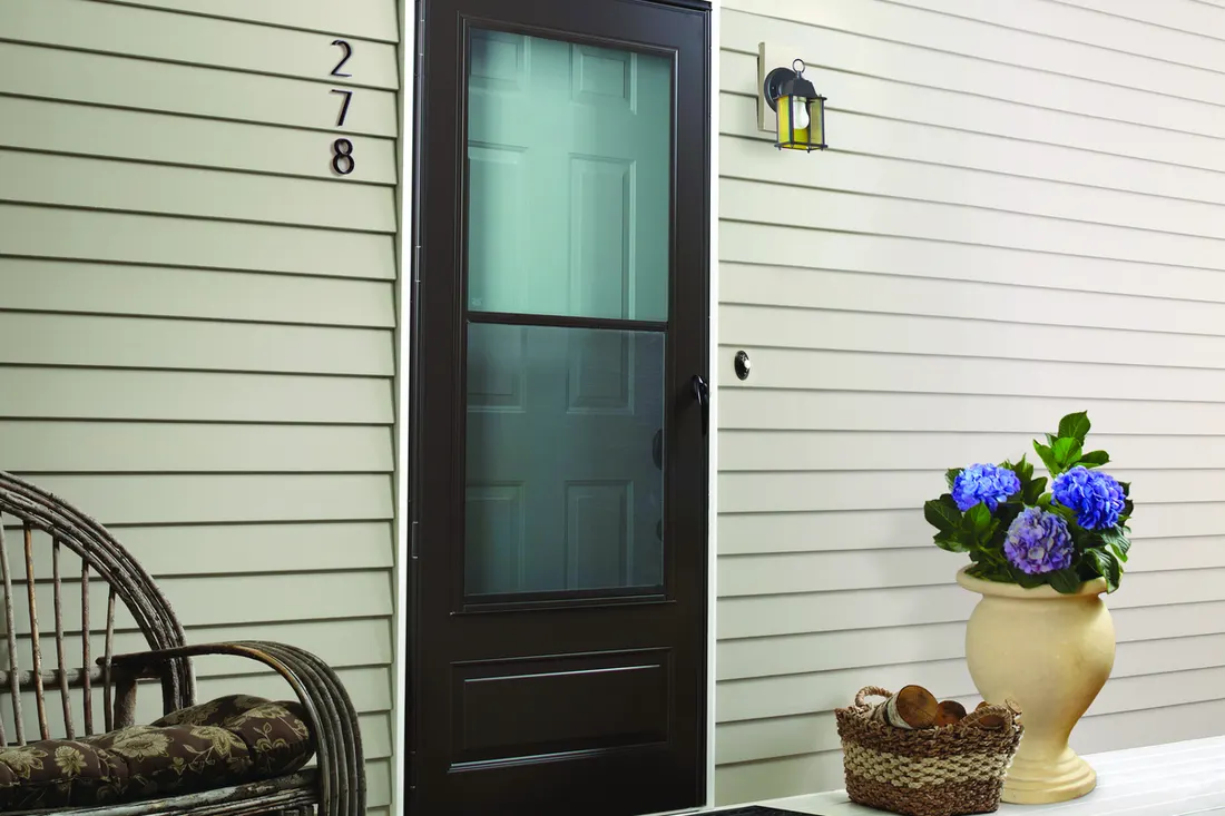Black full-view storm door with glass on a gray sided porch